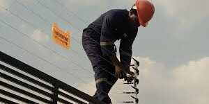 Person Installing Electric Fence Person Installing Electric Fence