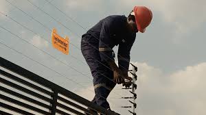 Person Installing Electric Fence Person Installing Electric Fence
